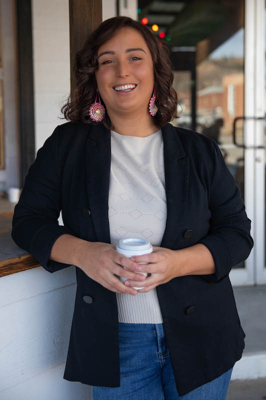 Michaela Madrid, Ward 3 candidate in the Spearfish City Council spring 2025 election, enjoys a cup of coffee in downtown Spearfish.